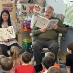 Man and woman read to children