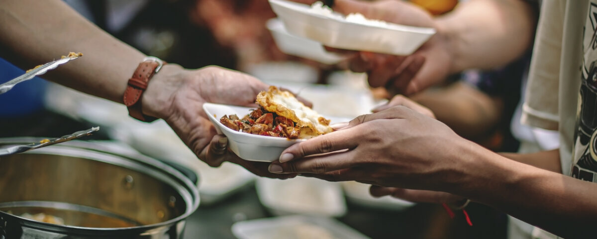 Handing a plate of food