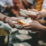 Handing a plate of food